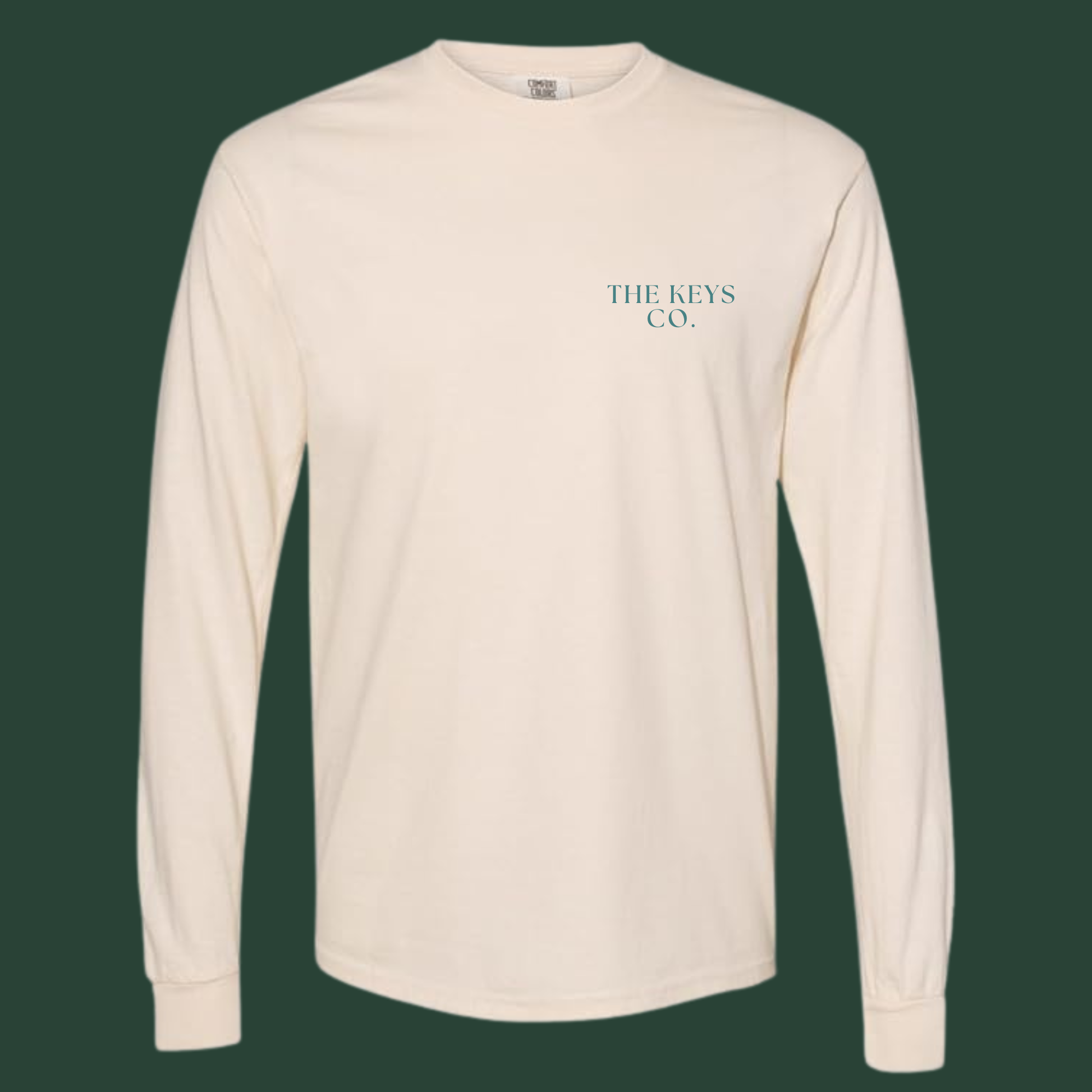 Beige long-sleeve shirt with 'THE KEYS CO.' logo on a dark green background