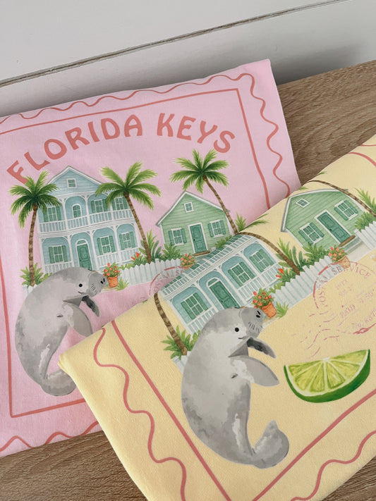 Two Shirts Pink & Yellow with Florida Keys-themed designs featuring houses and manatees.