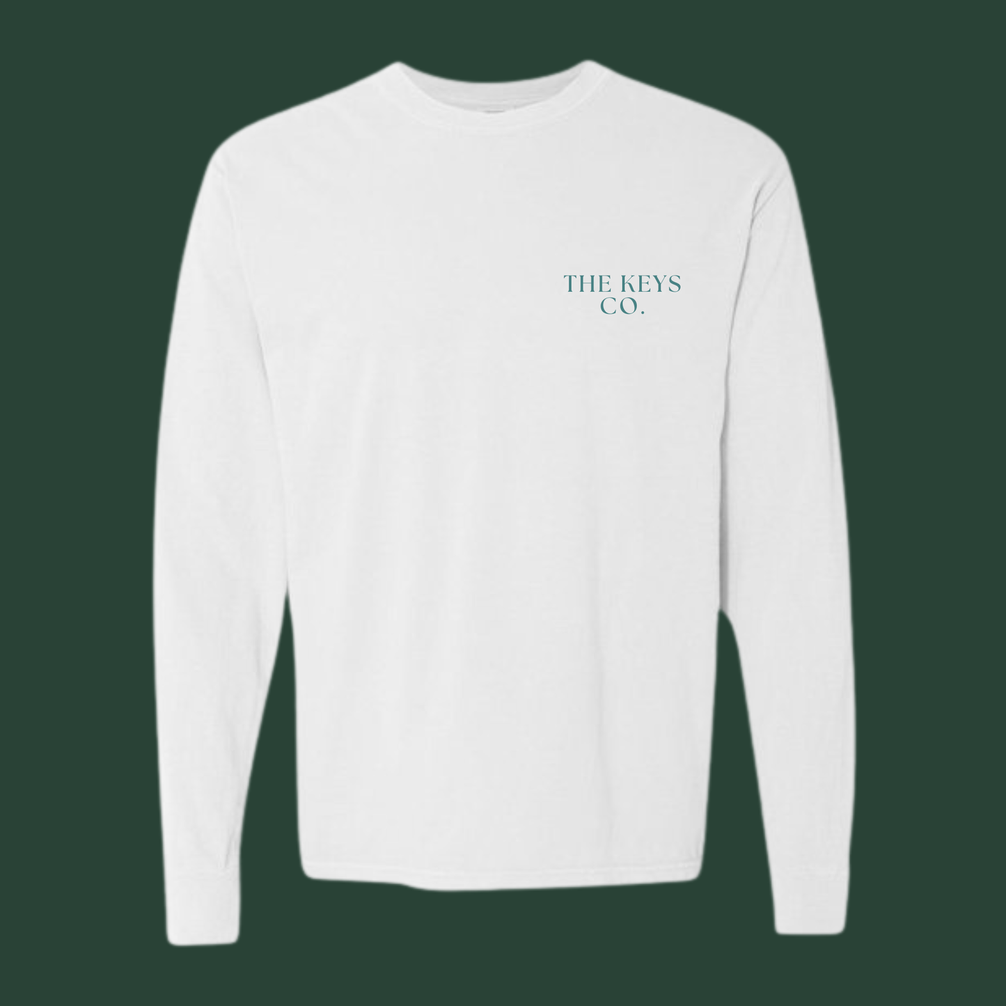 White long-sleeve shirt with 'THE KEYS CO.' logo on a dark green background